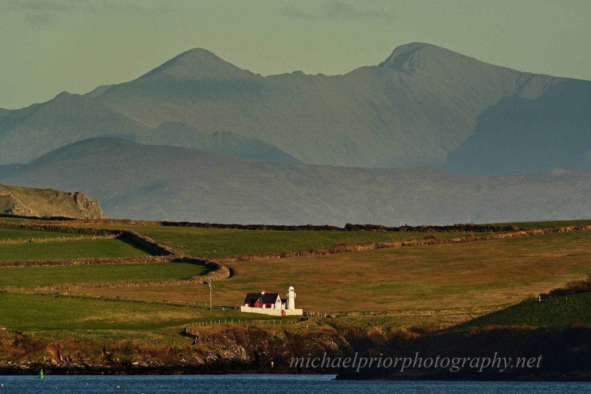 Dingle lighthouse with Carauntoohill in the distance